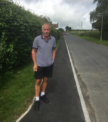 Local Councillor Derek Bastiman trying out the improved footpath
